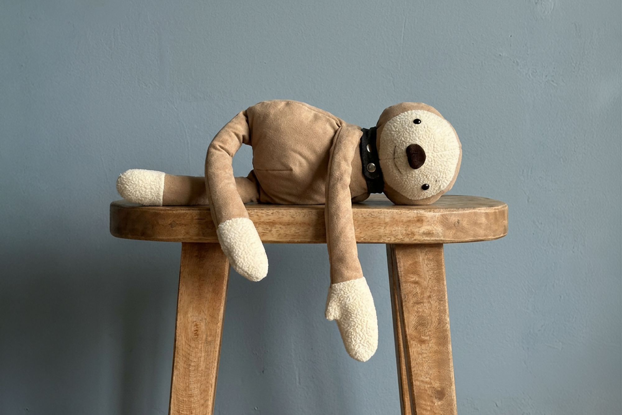 Sunny lying across a stool